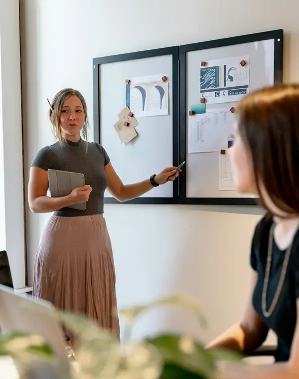 A strategist presenting a campaign board to her team