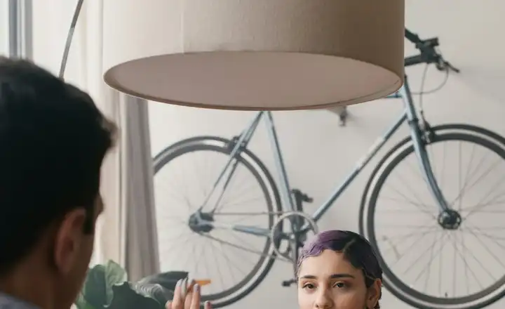 A consultant talking a client through her recommendations across a table