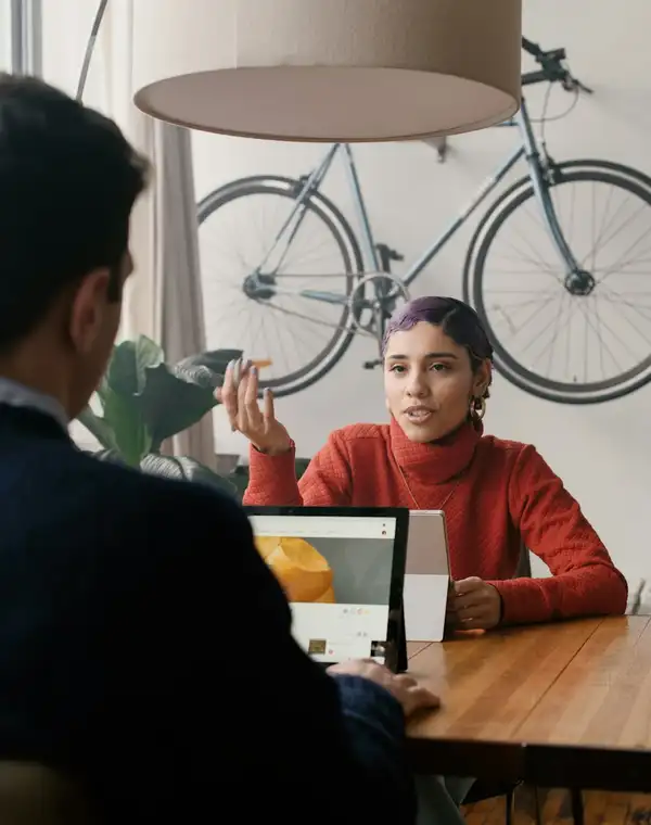 A consultant talking a client through her recommendations across a table
