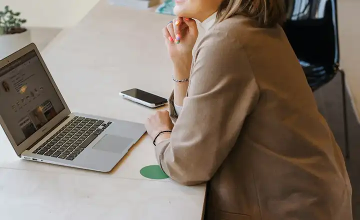 A freelancer at a laptop by the window of a quiet cafe