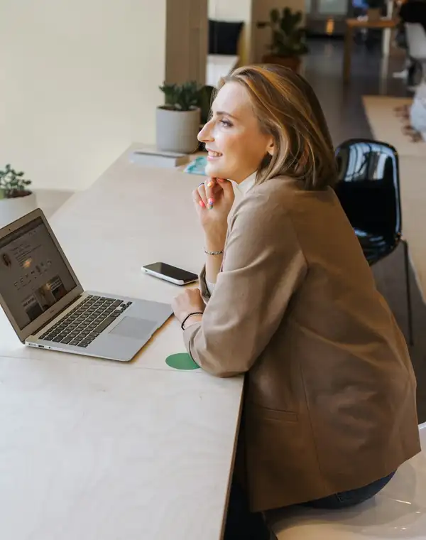 A freelancer at a laptop by the window of a quiet cafe