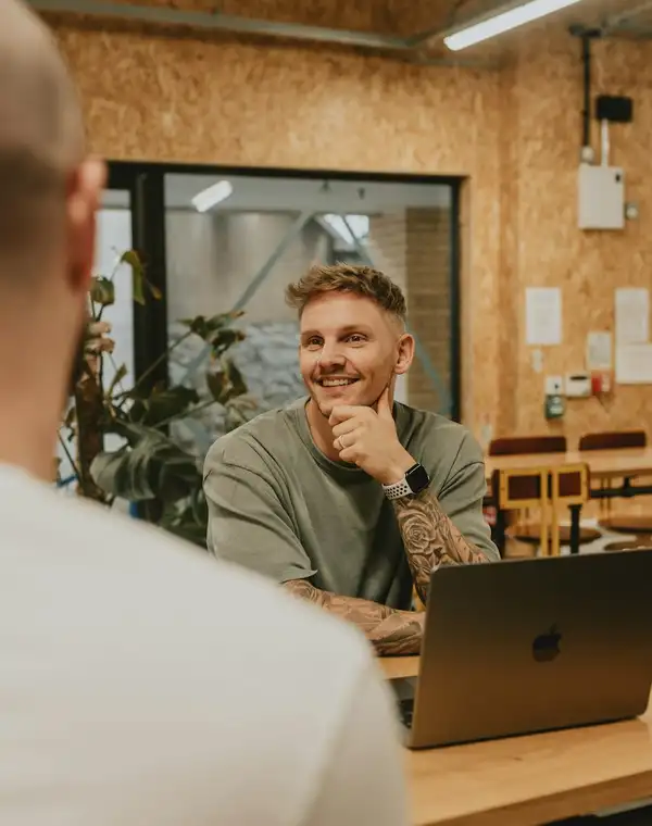 A prospect smiling across the table during a sales conversation
